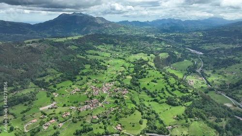 Aerial view of lush green mountain valley with village and forest, Infiesto, Asturias, Spain. photo