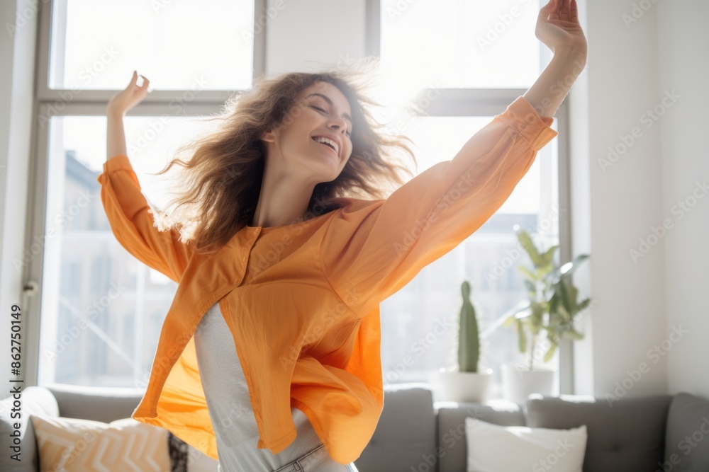 Joyful woman dancing in a bright living room