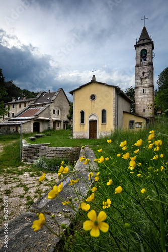 Obraz na płótnie Hamlet of Camposilvano: the church of San Carlo Borromeo and ancient houses in Cimbrian architecture. Velo Veronese, Lessinia, Veneto, Italy. w salonie