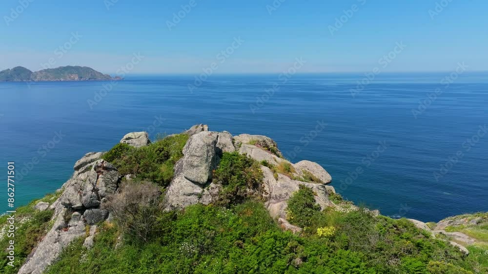 Rugged Boulder With Vegetation Near Cabo Home In Pontevedra, Spain. orbiting drone shot Rugged Boulder With Vegetation Near Cabo Home In Pontevedra, Spain. orbiting drone shot