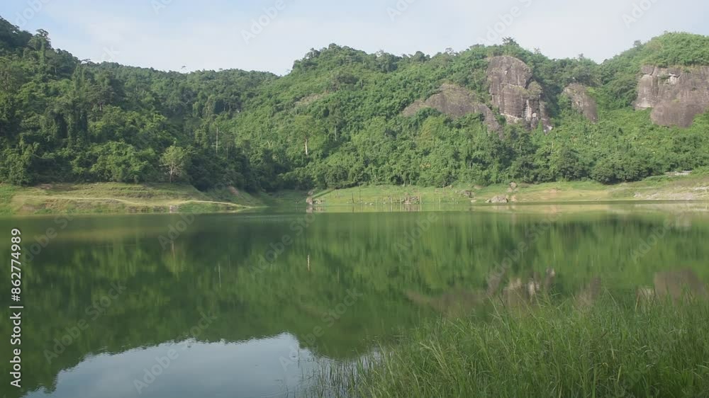 landscape of Klong Klang water reservoir lake with mountain background in Thailand landscape of Klong Klang water reservoir lake with mountain background in Thailand