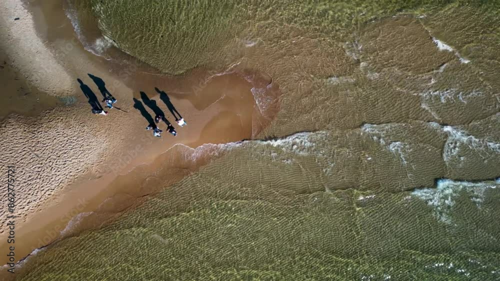 People traveling thru beach near waving Baltic Sea in Hel Poland	