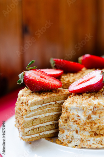 Crepe cake Medovik with sour cream vanilla cream and strawberries. Pancake cake Medovik decorated with strawberries.