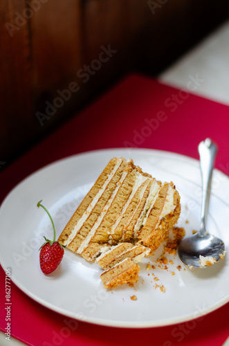 Slice Crepe cake Medovik with sour cream vanilla cream and strawberries. Slice Pancake cake Medovik decorated with strawberries.