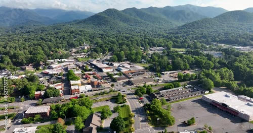 Aerial view of Black Mountain, NC, showcasing a small town surrounded by lush greenery and mountains in the background.