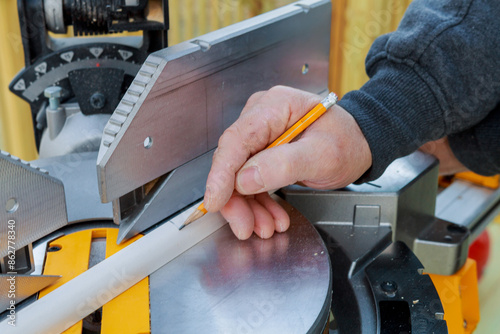 Cutting wooden moldings on circular saw before installing them is form of using circular saw by contractor © ungvar