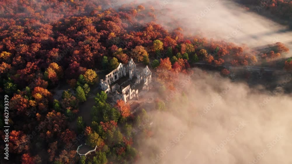 Epic Castle on Hill Drone Circles Around Cliff Edge Fantasy Fog Low Clouds Dramatic Landscape. Sunrise Rays Across Landmark Castle Ruins Ha Ha Tonka Missouri.