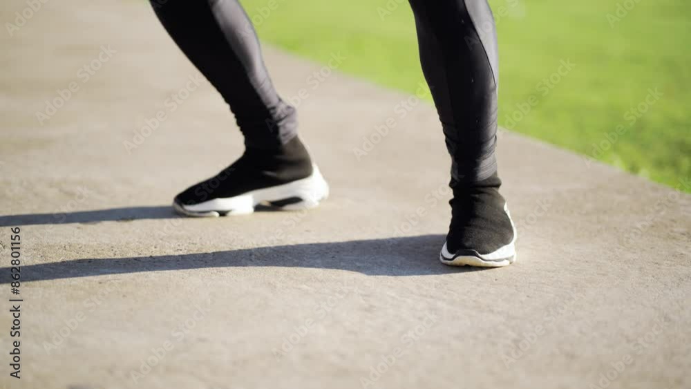 Detail shot of an athlete's feet performing squat jumps, capturing the power and agility required in a fitness regimen. Lower body workout in progress, emphasizing the muscular endurance Detail shot of an athlete's feet performing squat jumps, capturing the power and agility required in a fitness regimen. Lower body workout in progress, emphasizing the muscular endurance