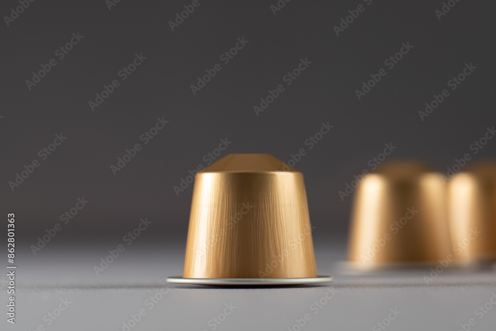 Coffee capsules in focus with others blurred in the background, creating a sense of depth Coffee capsules in focus with others blurred in the background, creating a sense of depth