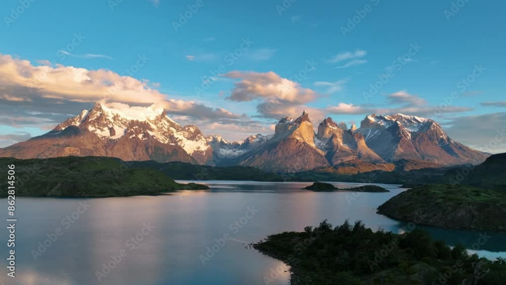 Aerial view of snowcapped mountains and serene lake in Torres del Paine, Patagonia, Chile.