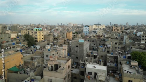 Aerial view of densely populated Lyari with residential rooftops and urban skyline, Karachi, Pakistan.