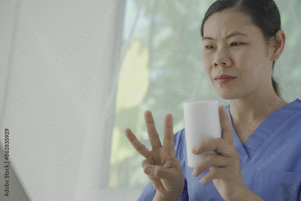 Pharmacist holds a prescription and tries to explain how to use the medicine to a patient. Pharmacy. Asian female health worker is explaining a prescription to a patient. Medicine Pharmacist.