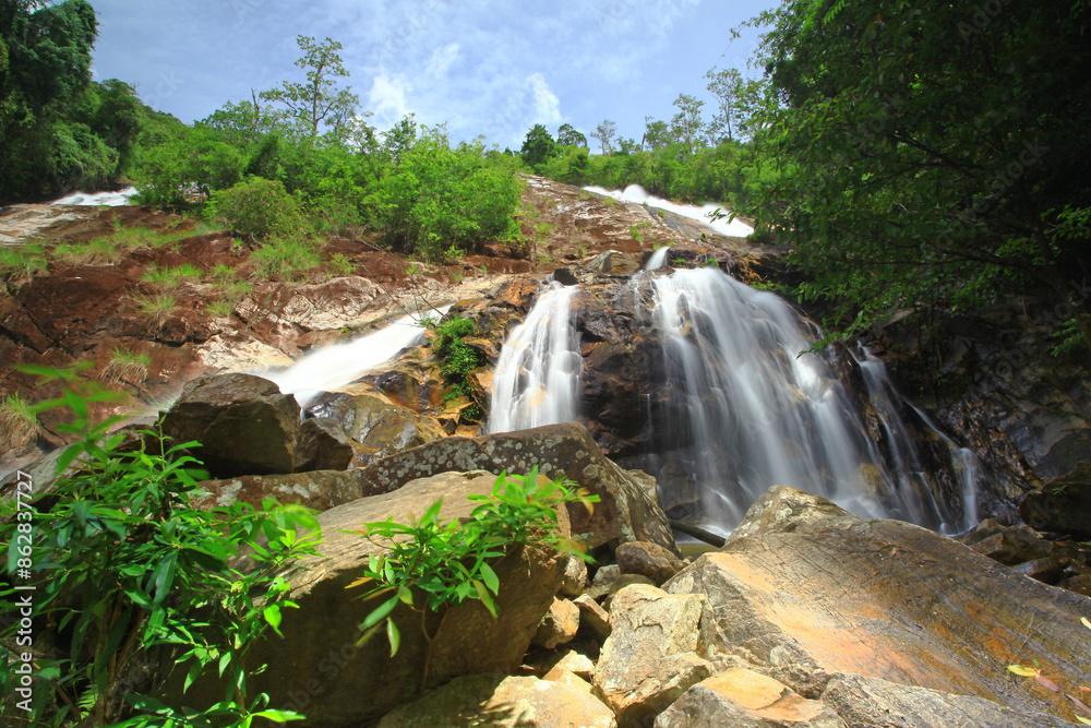 Naklejka premium Scenic of namtok ton nga chang waterfall or The Elephant Tusks Waterfall at Tone Nga Chang wildlife sanctuary in Songkhla Province, Thailand 