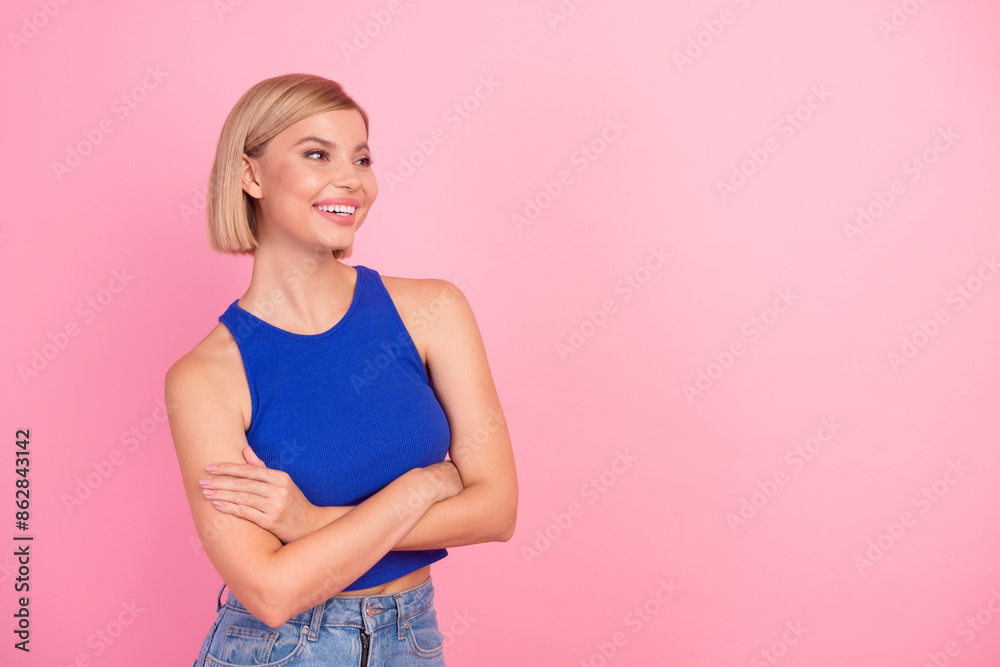 Portrait of nice young girl crossed arms look empty space wear blue top isolated on pink color background Portrait of nice young girl crossed arms look empty space wear blue top isolated on pink color background