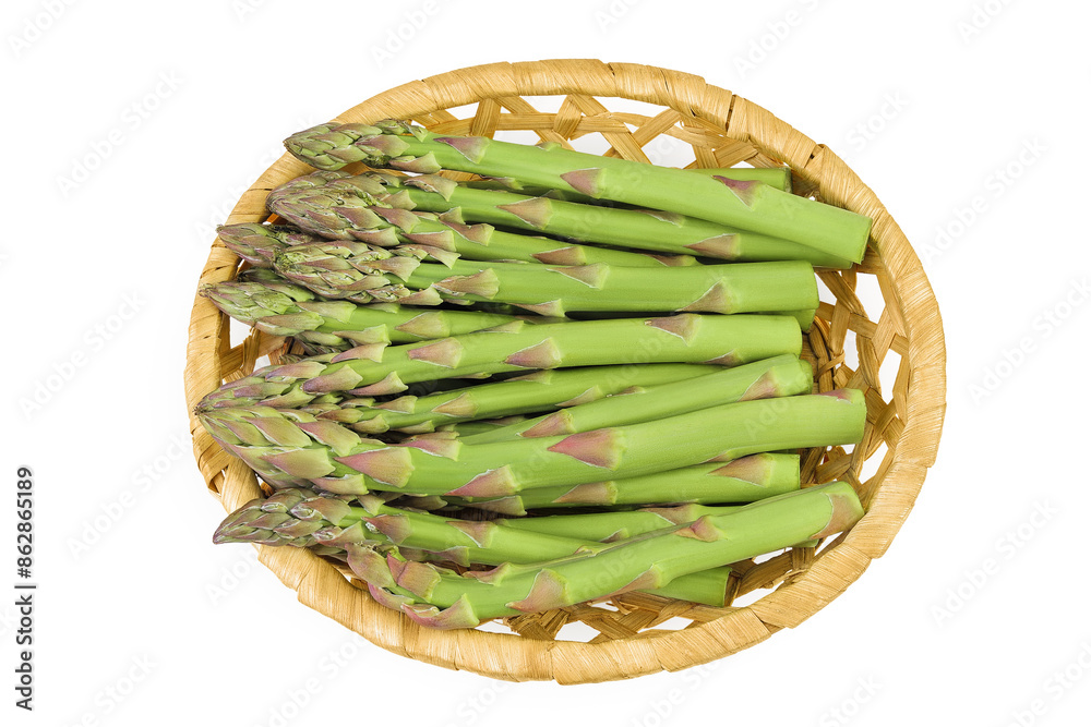 fresh asparagus in in a wicker basket isolated on white background. Top view. Flat lay. fresh asparagus in in a wicker basket isolated on white background. Top view. Flat lay.