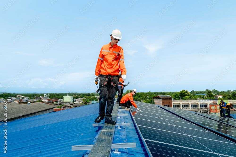 engineer man inspects construction of solar cell panel or photovoltaic cell by electronic device. Industrial Renewable energy of green power. factory worker working on tower roof. engineer man inspects construction of solar cell panel or photovoltaic cell by electronic device. Industrial Renewable energy of green power. factory worker working on tower roof.