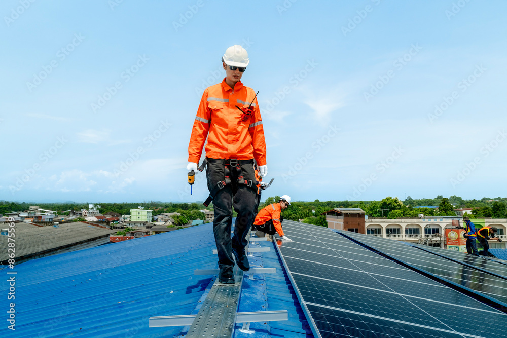 engineer man inspects construction of solar cell panel or photovoltaic cell by electronic device. Industrial Renewable energy of green power. factory worker working on tower roof. engineer man inspects construction of solar cell panel or photovoltaic cell by electronic device. Industrial Renewable energy of green power. factory worker working on tower roof.