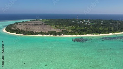 Aerial view of tropical island paradise with lagoon, beach, and coral reefs, Thoddoo Atoll, Maldives. photo