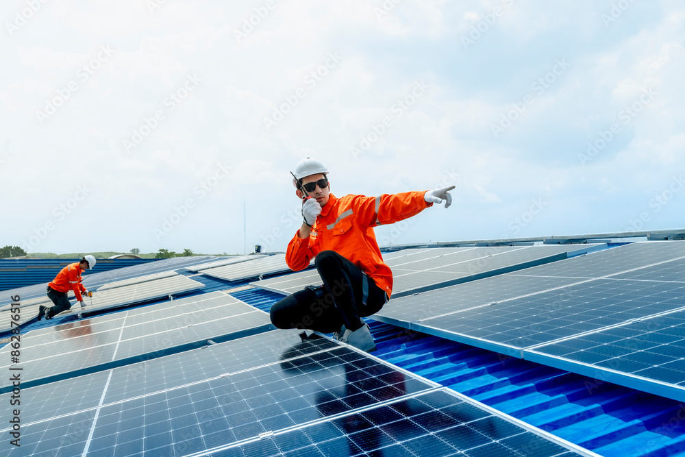 engineer man inspects construction of solar cell panel or photovoltaic cell by electronic device. Industrial Renewable energy of green power. factory worker working on tower roof. engineer man inspects construction of solar cell panel or photovoltaic cell by electronic device. Industrial Renewable energy of green power. factory worker working on tower roof.