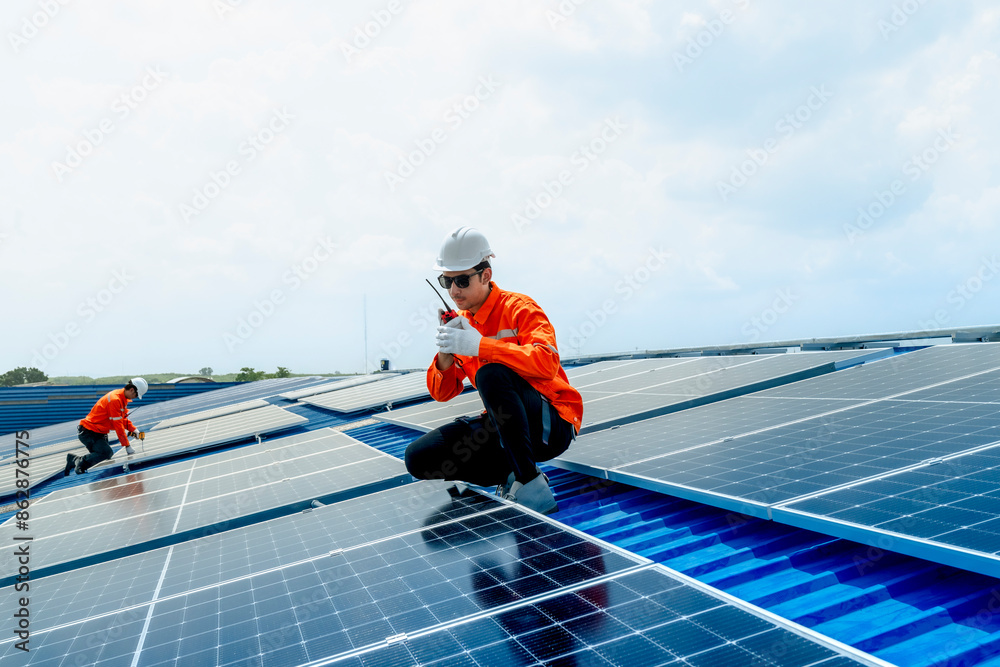 engineer man inspects construction of solar cell panel or photovoltaic cell by electronic device. Industrial Renewable energy of green power. factory worker working on tower roof. engineer man inspects construction of solar cell panel or photovoltaic cell by electronic device. Industrial Renewable energy of green power. factory worker working on tower roof.