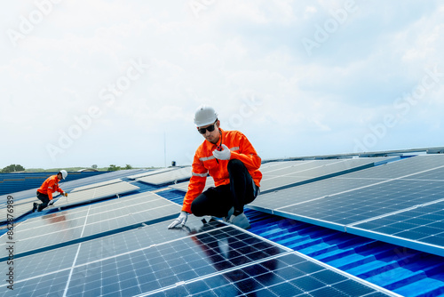 Wallpaper Mural engineer man inspects construction of solar cell panel or photovoltaic cell by electronic device. Industrial Renewable energy of green power. factory worker working on tower roof. Torontodigital.ca