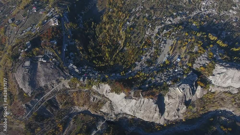 Aerial view of Hunza Valley with trees, village, cliffs, and rock formations, Gilgit-Baltistan, Pakistan. Aerial view of Hunza Valley with trees, village, cliffs, and rock formations, Gilgit-Baltistan, Pakistan.