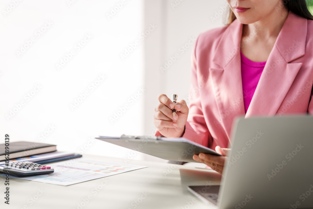 40-year-old middle-aged Asian businesswoman wearing pink suit, business finance, investment strategies, risk management. Skilled in planning, analysis, operations control for business success. 40-year-old middle-aged Asian businesswoman wearing pink suit, business finance, investment strategies, risk management. Skilled in planning, analysis, operations control for business success.