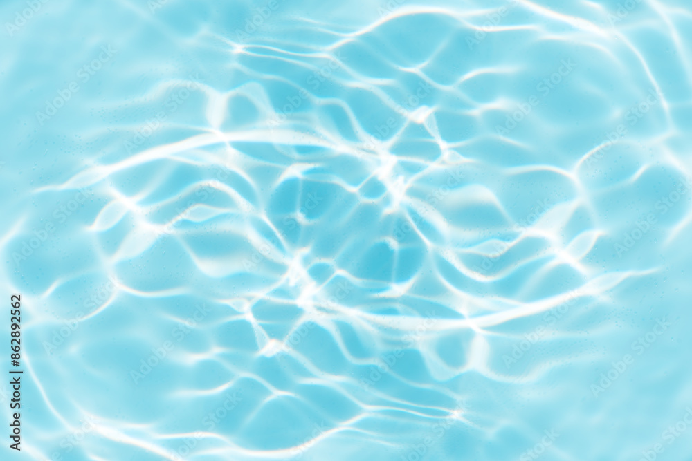 Blue water with ripples on the surface. Defocus blurred transparent blue colored clear calm water surface texture with splashes and bubbles. Water waves with shining pattern texture background. Blue water with ripples on the surface. Defocus blurred transparent blue colored clear calm water surface texture with splashes and bubbles. Water waves with shining pattern texture background.