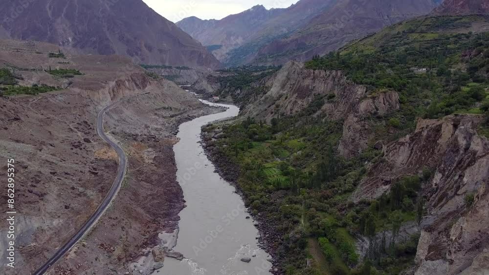 Aerial view of majestic Hunza Valley with river, road, and mountains, Gilgit-Baltistan, Pakistan. Aerial view of majestic Hunza Valley with river, road, and mountains, Gilgit-Baltistan, Pakistan.