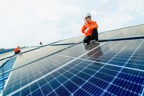 Wallpaper Mural engineer man inspects construction of solar cell panel or photovoltaic cell by electronic device. Industrial Renewable energy of green power. factory worker working on tower roof. Torontodigital.ca