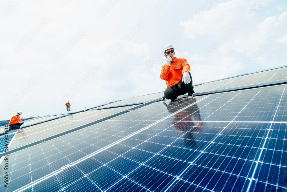 engineer man inspects construction of solar cell panel or photovoltaic cell by electronic device. Industrial Renewable energy of green power. factory worker working on tower roof. engineer man inspects construction of solar cell panel or photovoltaic cell by electronic device. Industrial Renewable energy of green power. factory worker working on tower roof.
