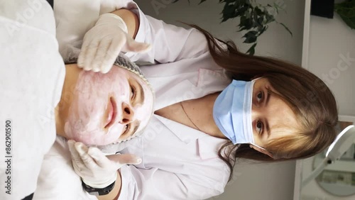 Video filmed in a beauty salon while the professional in the field of facial beauty explains to the client how to protect and what kind of special creams to use for a beautiful complexion. Special