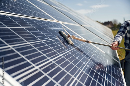 Close up view of cleaning solar panels surface photo