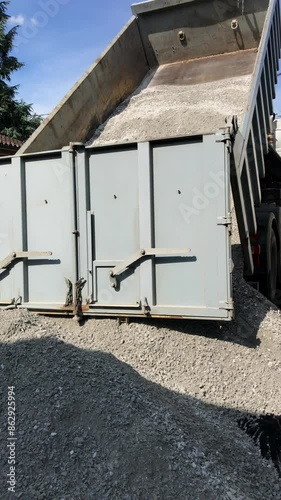 Dump Truck emptying gravel for an earthworks job in the driveway of a detached house, High quality 4k footage