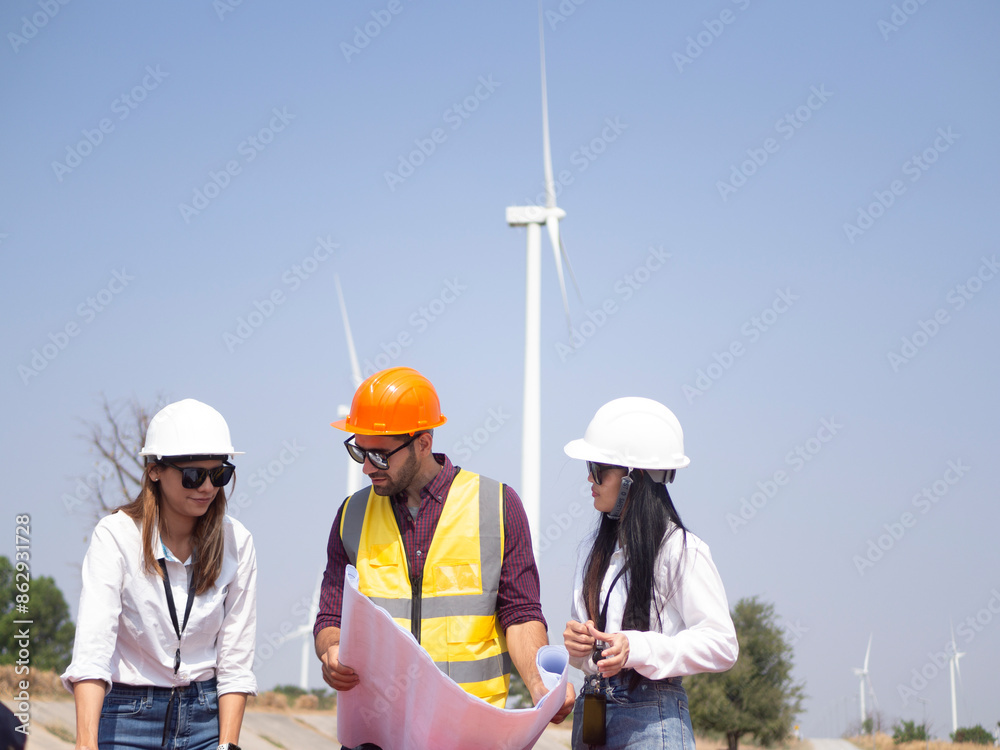 A group of engineers and architects are consulting. About taking care of wind turbines For a sustainable environment A group of engineers and architects are consulting. About taking care of wind turbines For a sustainable environment