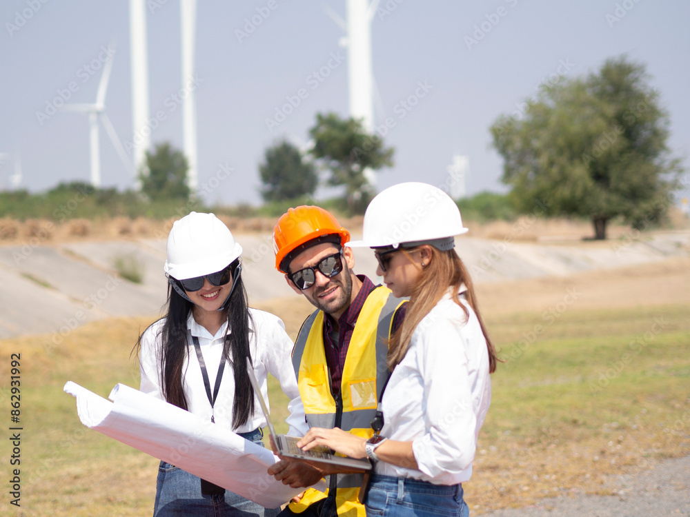 A group of engineers and architects are consulting. About taking care of wind turbines For a sustainable environment A group of engineers and architects are consulting. About taking care of wind turbines For a sustainable environment