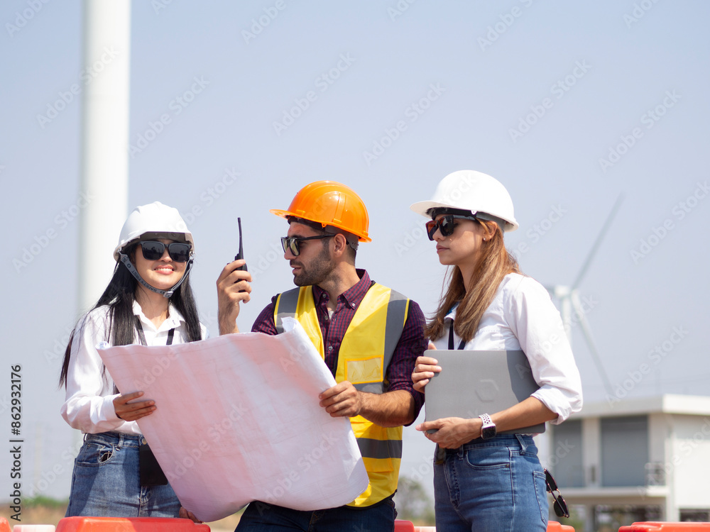 A group of engineers and architects are consulting. About taking care of wind turbines For a sustainable environment A group of engineers and architects are consulting. About taking care of wind turbines For a sustainable environment
