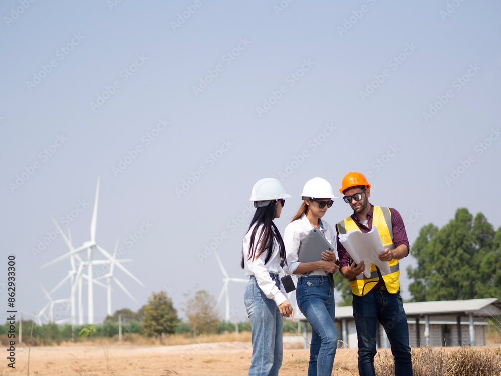 A group of engineers and architects are consulting. About taking care of wind turbines For a sustainable environment A group of engineers and architects are consulting. About taking care of wind turbines For a sustainable environment
