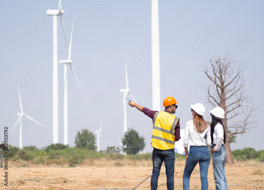 A group of engineers and architects are consulting. About taking care of wind turbines For a sustainable environment A group of engineers and architects are consulting. About taking care of wind turbines For a sustainable environment