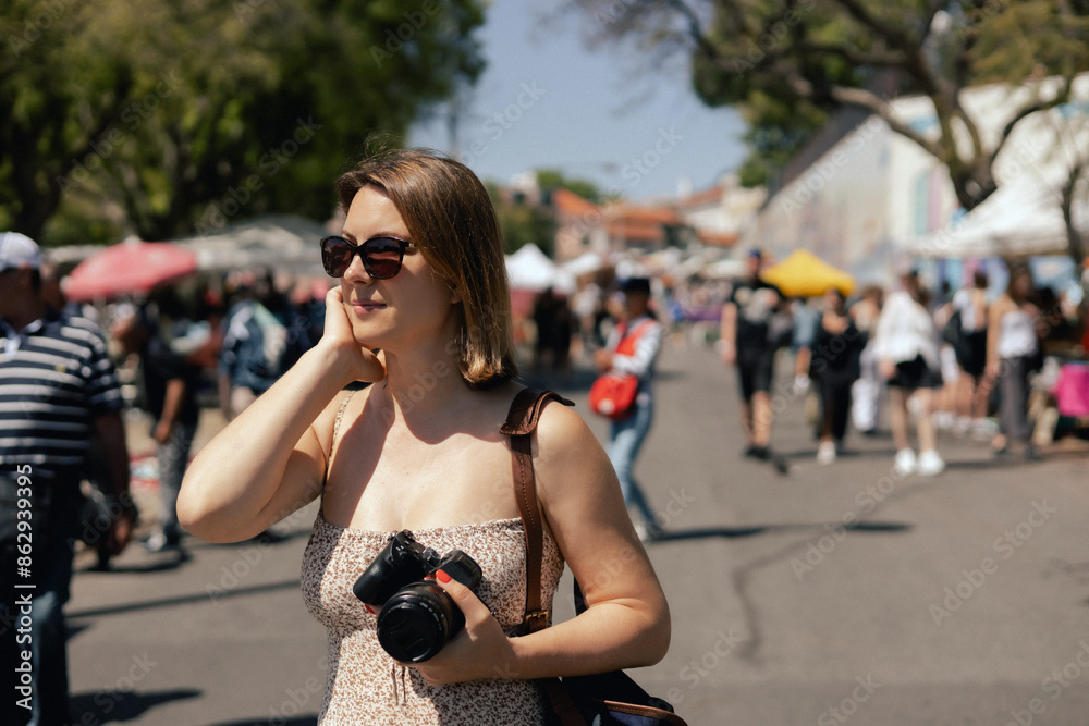 Middle-aged woman taking a photo on a camera on flea market. Garage sale, reuse the clothes, second hand and eco consumer. Close-up. Selective focus Middle-aged woman taking a photo on a camera on flea market. Garage sale, reuse the clothes, second hand and eco consumer. Close-up. Selective focus