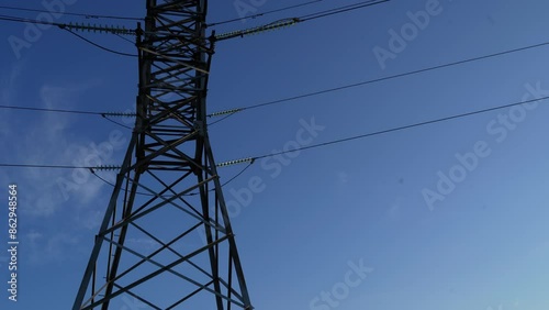 High voltage steel power pylons in field covered.   Power transmission lines. Electric tower line