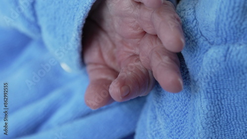 Macro close-up of infant newborn baby hand during first day of life © Marco