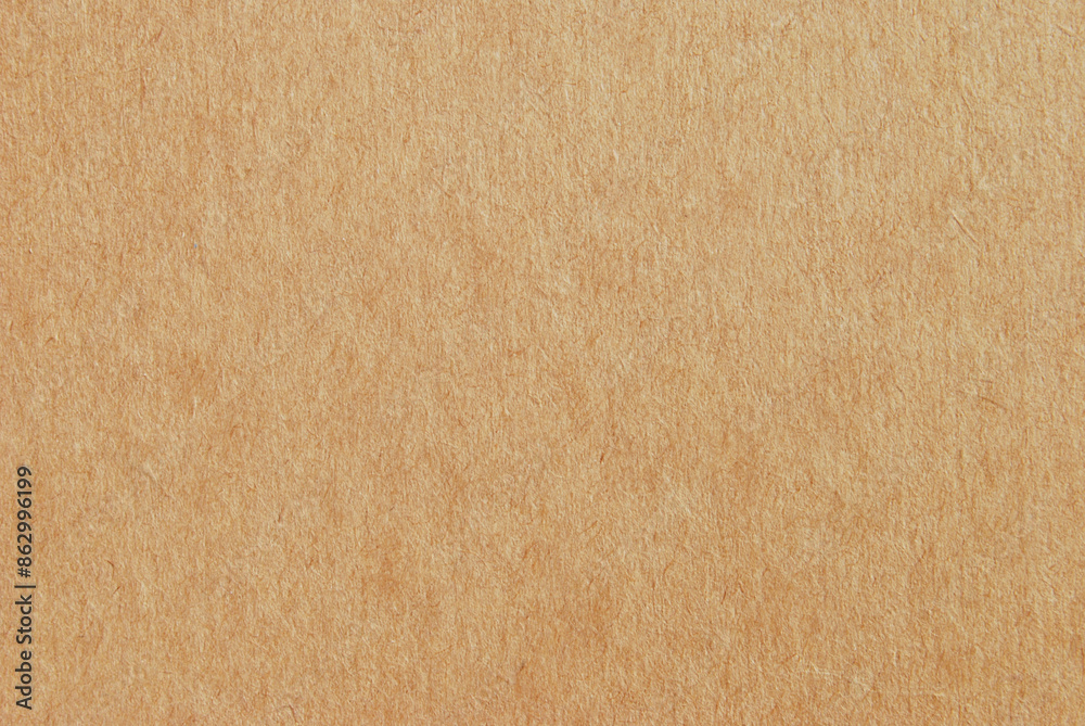 A sheet of brown recycled cardboard texture as background A sheet of brown recycled cardboard texture as background