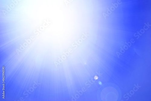 Abstract light blue background with de focused sun light and bokeh effect