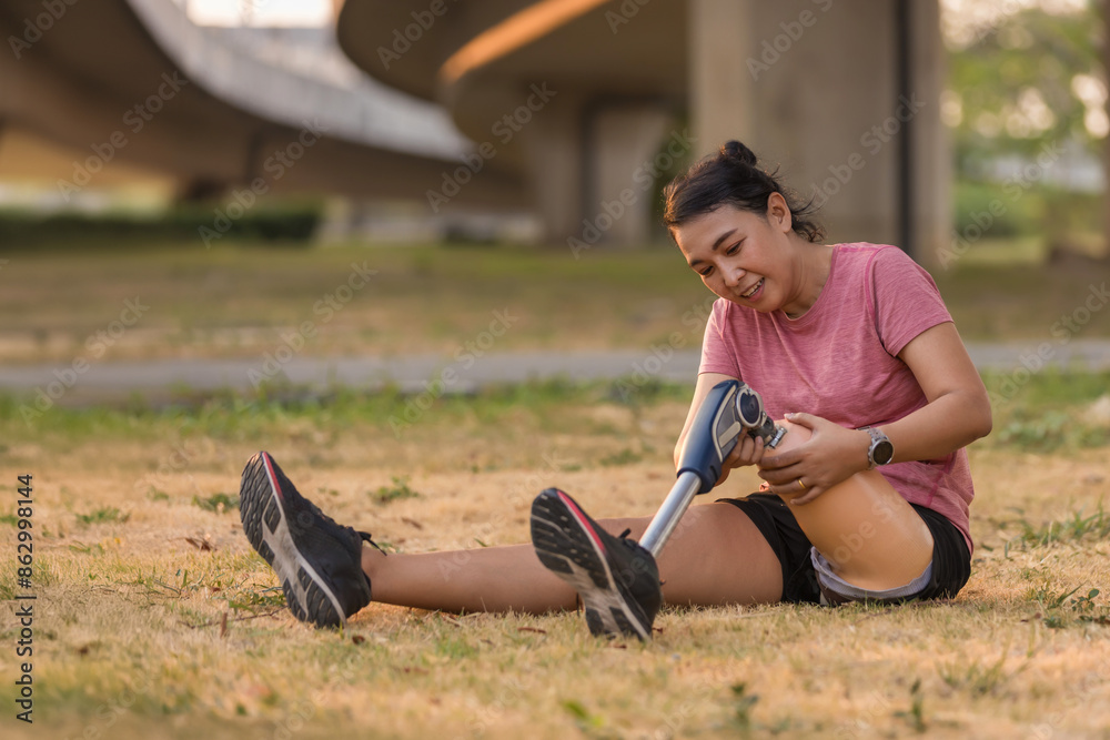 Athlete with prosthetic leg doing warm up exercise on park. Woman wearing prosthetic equipment for jogging. Athlete with prosthetic leg doing warm up exercise on park. Woman wearing prosthetic equipment for jogging.