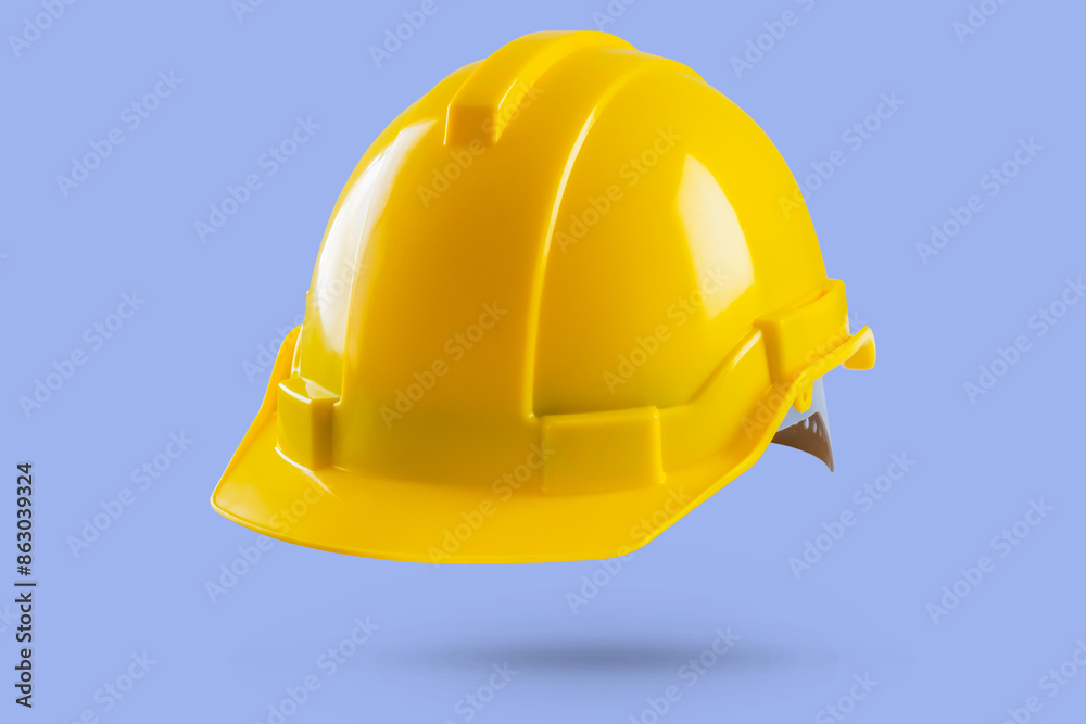 Fototapeta premium Yellow safety construction helmet on blue background