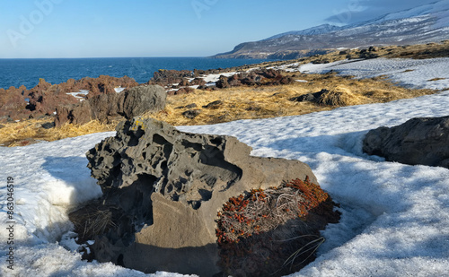 Russia. Far East, Kuril Islands. Very hard and sharp basalt rocks along the coast of the Sea of Okhotsk on the island of Iturup.