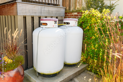 Quadro su tela Propane tanks in a house backyard on a sunny autumn day