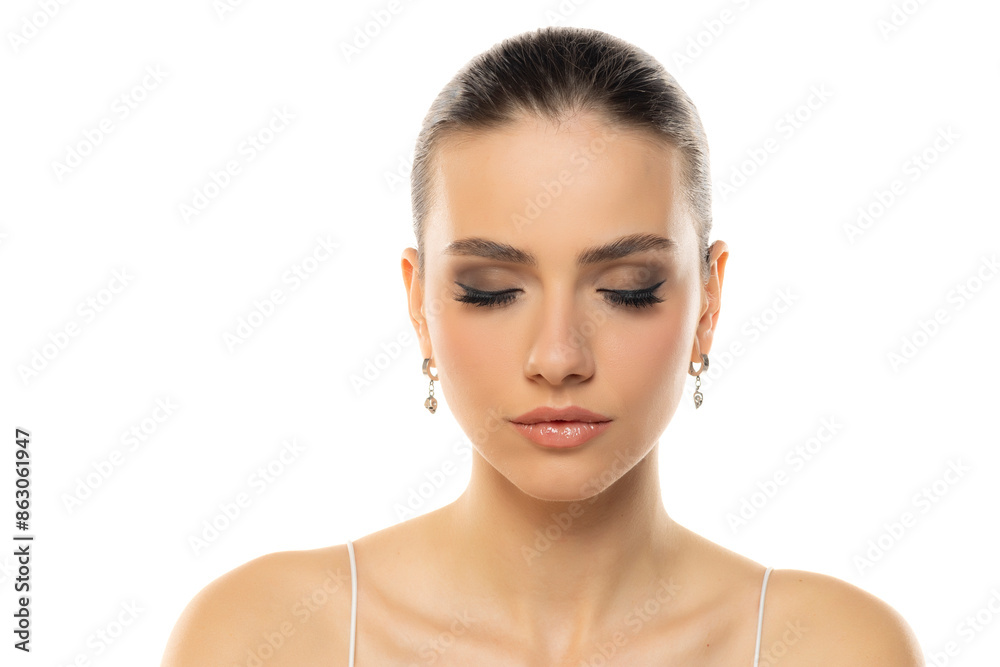 portrait of a young serious teenage girl witht makeup closed eyes and tied hair on a white background portrait of a young serious teenage girl witht makeup closed eyes and tied hair on a white background