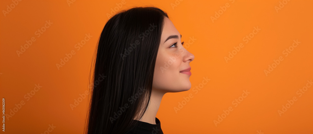 Closeup portrait. Beautiful young girl with black hair in profile on orange background Generative AI Closeup portrait. Beautiful young girl with black hair in profile on orange background Generative AI
